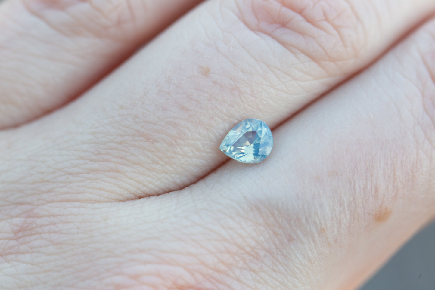 ON HOLD .82ct pear icy opalescent blue sapphire