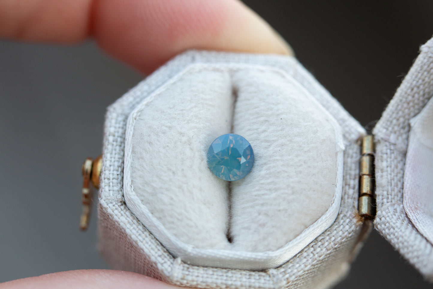 Load image into Gallery viewer, .85ct round opalescent blue teal sapphire
