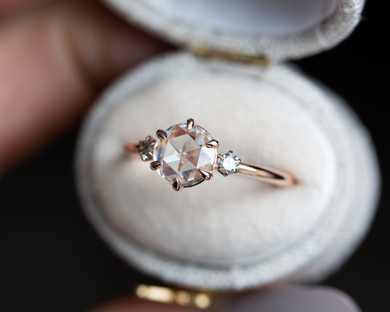 Rose cut three stone ring with grey diamond side stones