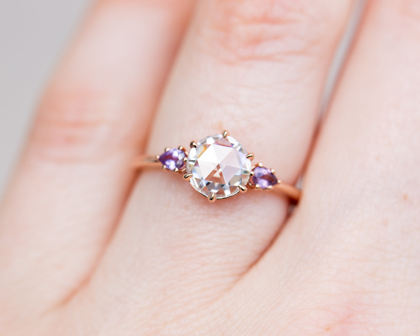Rose cut moissanite three stone ring with purple sapphire side stones