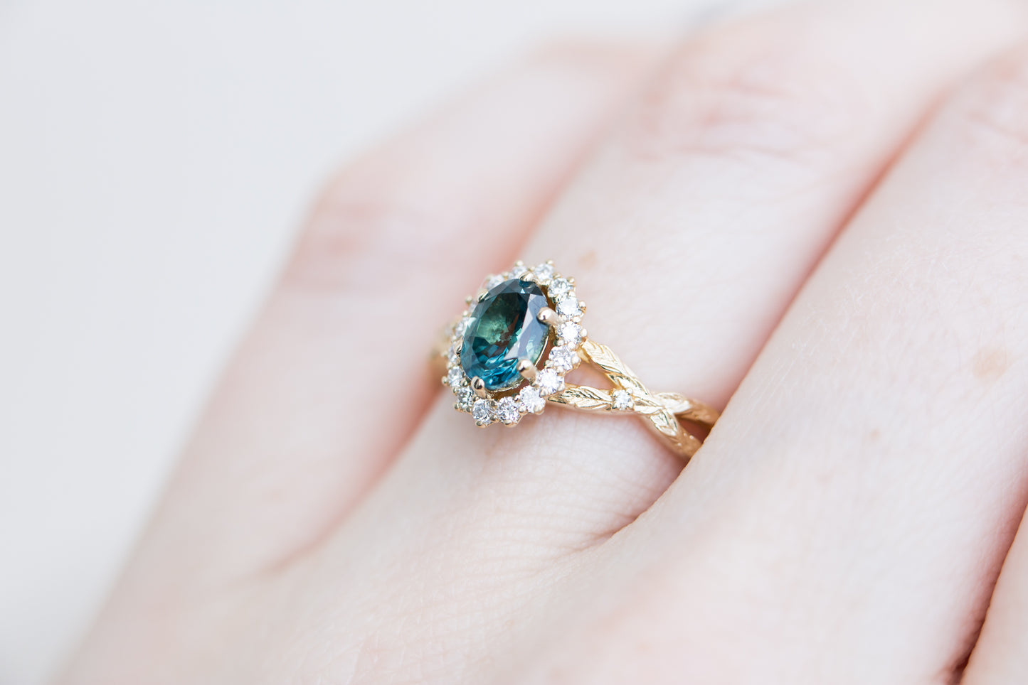 Oval Montana sapphire halo twisted leaf ring