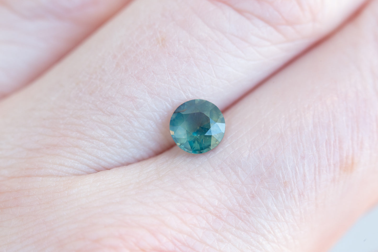 1.26ct round opalescent teal sapphire