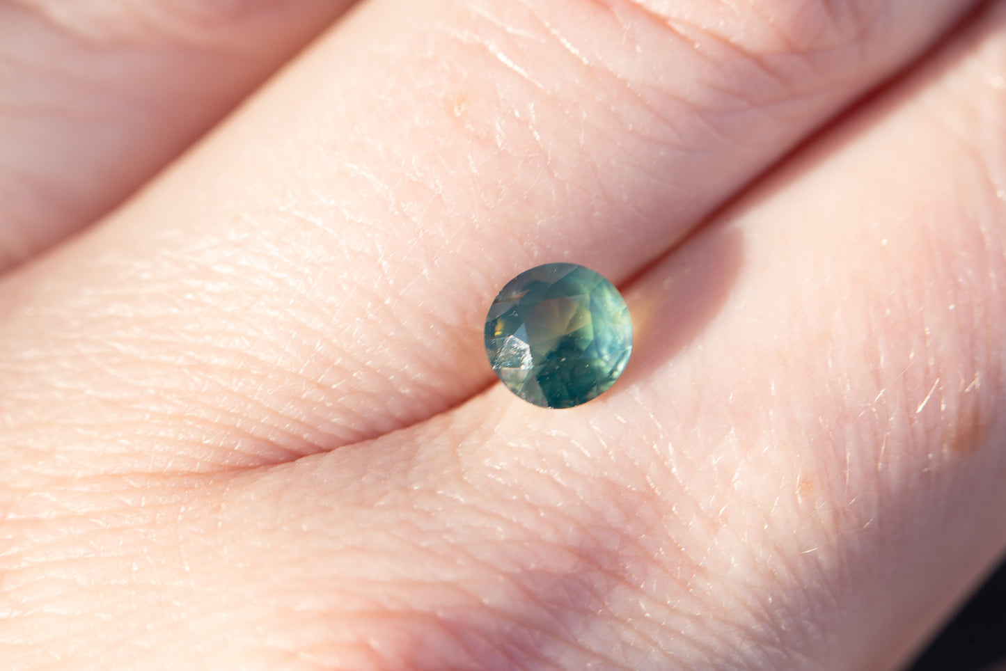 1.26ct round opalescent teal sapphire