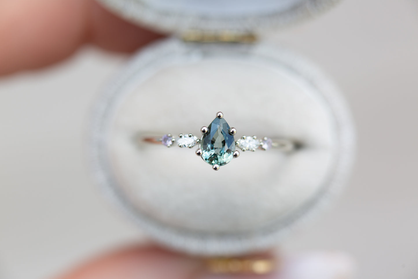 Pear teal Montana sapphire five stone ring with diamonds and lavender sapphire