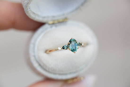 Oval Montana sapphire five stone with teal sapphire side stones