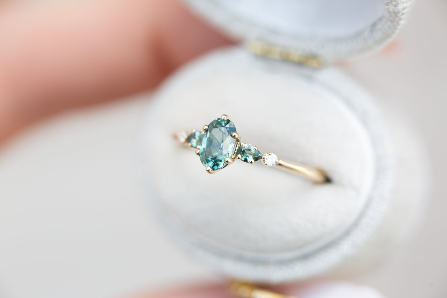 Oval Montana sapphire five stone with teal sapphire side stones
