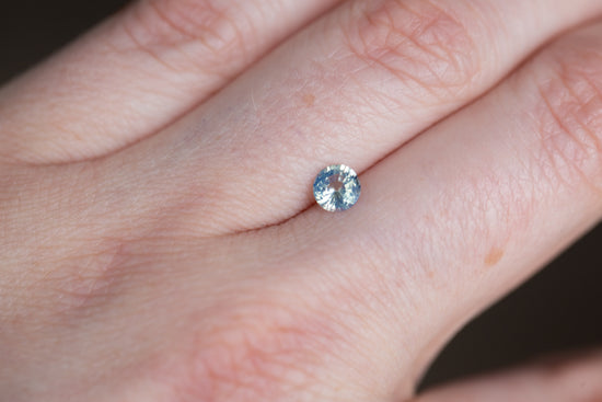 Load image into Gallery viewer, .57ct round opalescent blue sapphire
