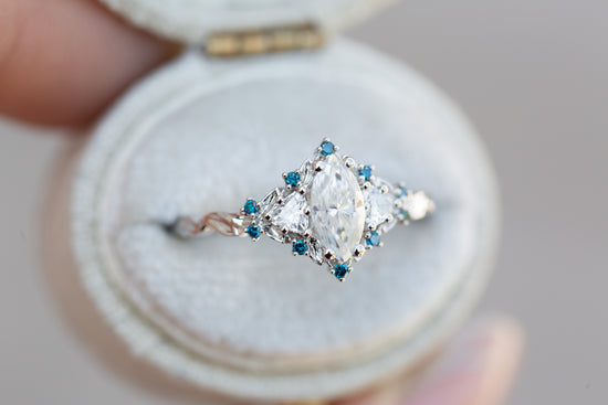 Briar rose three stone with marquise moissanite and irradiated blue diamonds