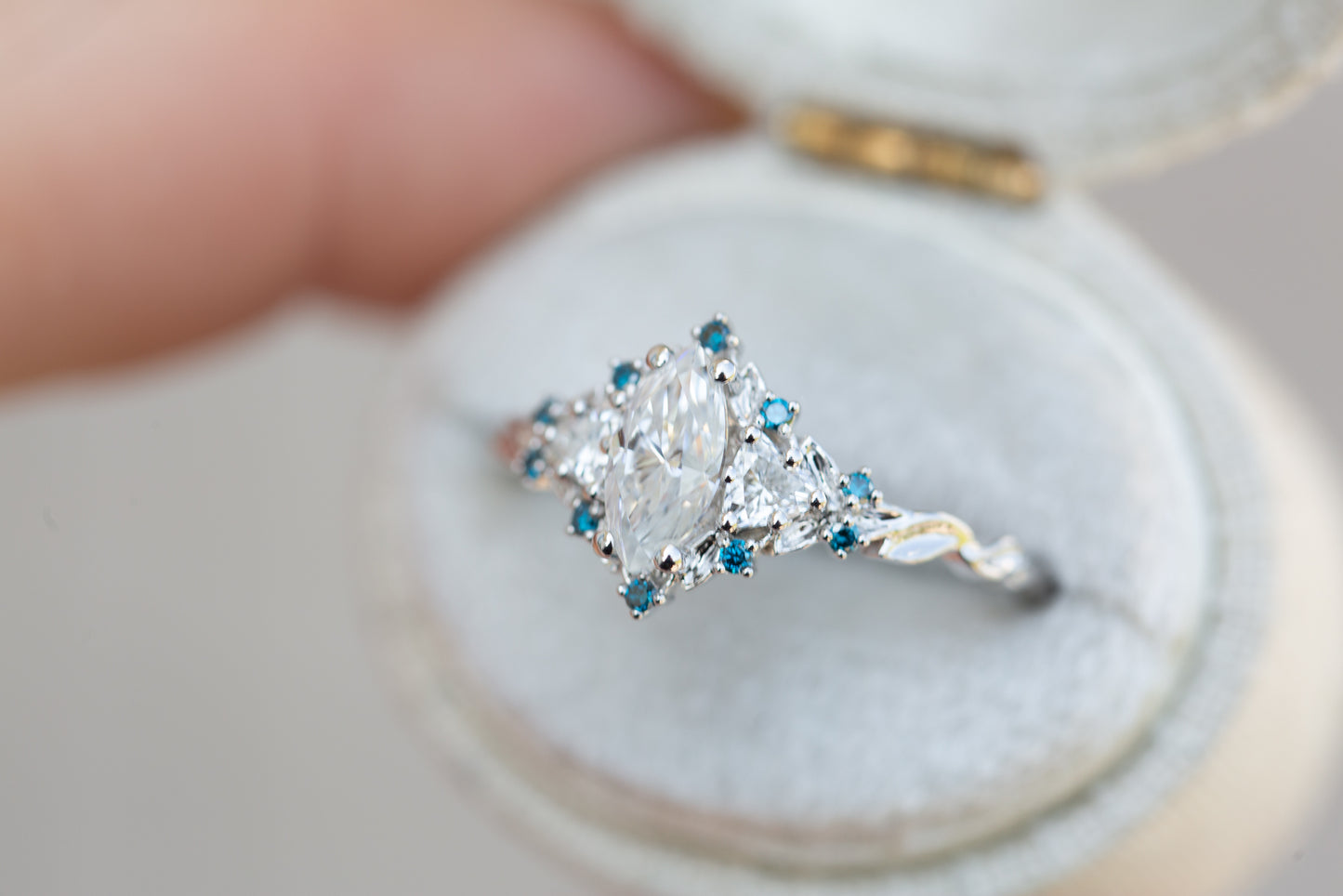 Briar rose three stone with marquise moissanite and irradiated blue diamonds