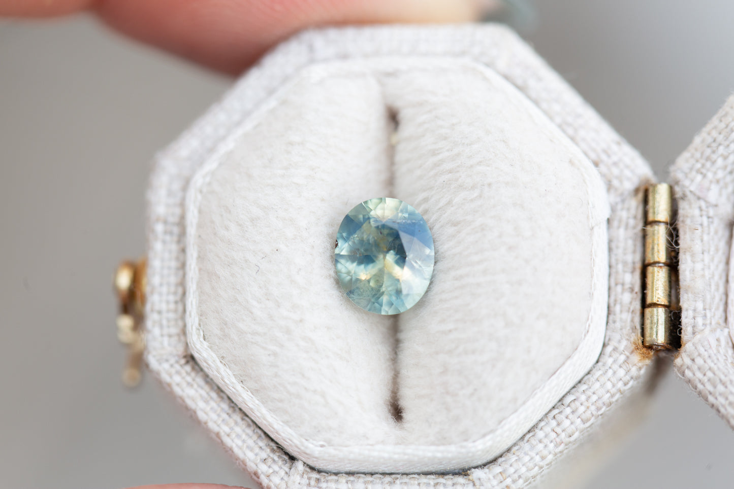 1.33ct oval murky opalescent light blue/teal sapphire