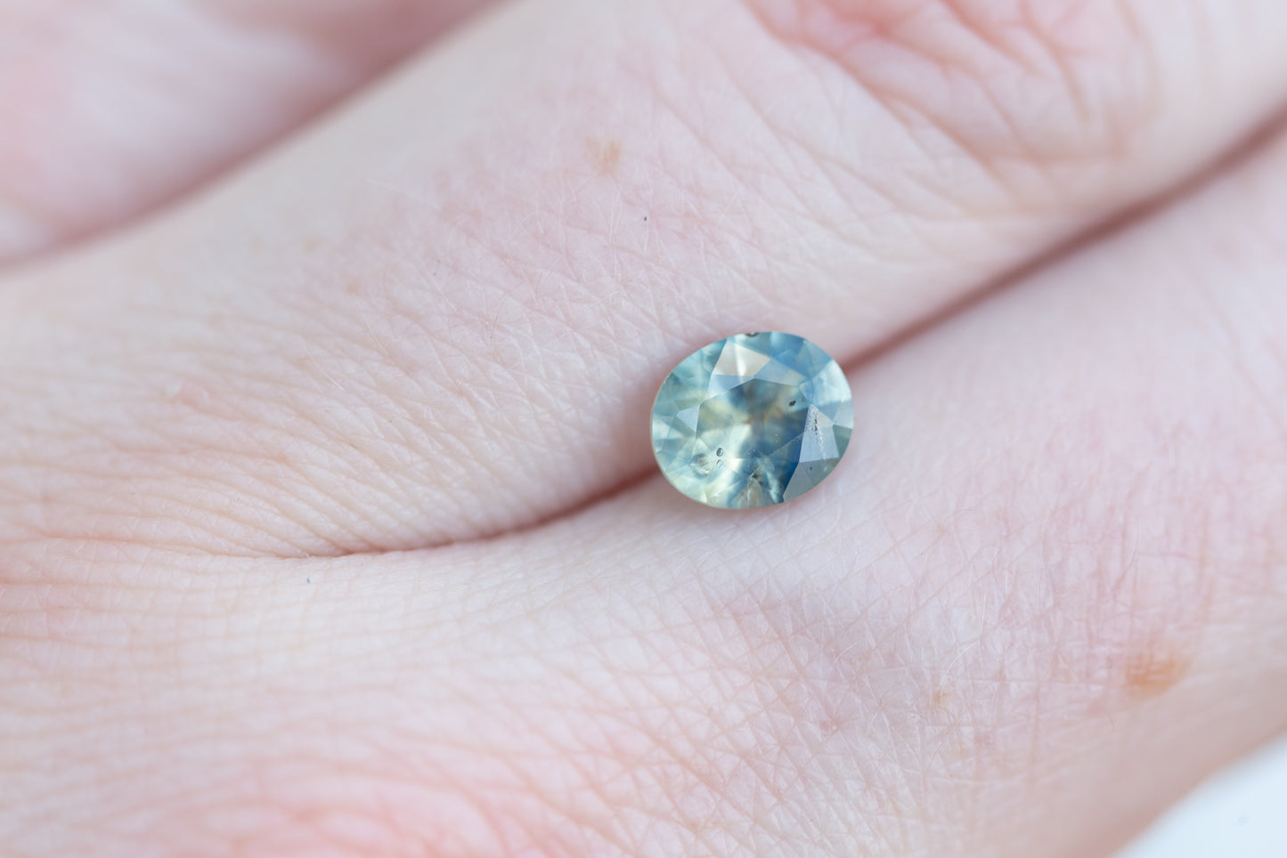 1.33ct oval murky opalescent light blue/teal sapphire