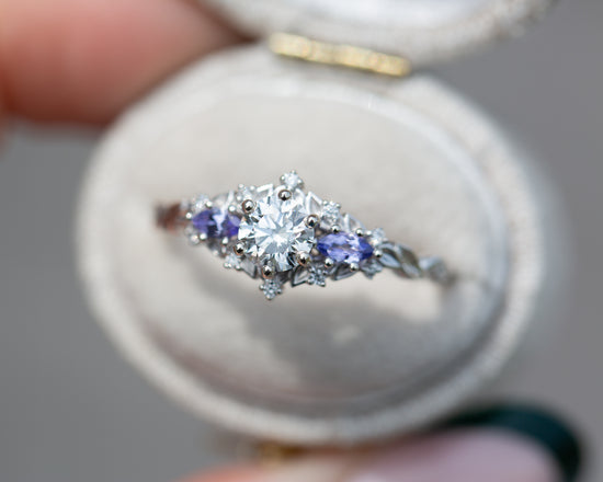 Briar rose three stone with round center and tanzanite sides