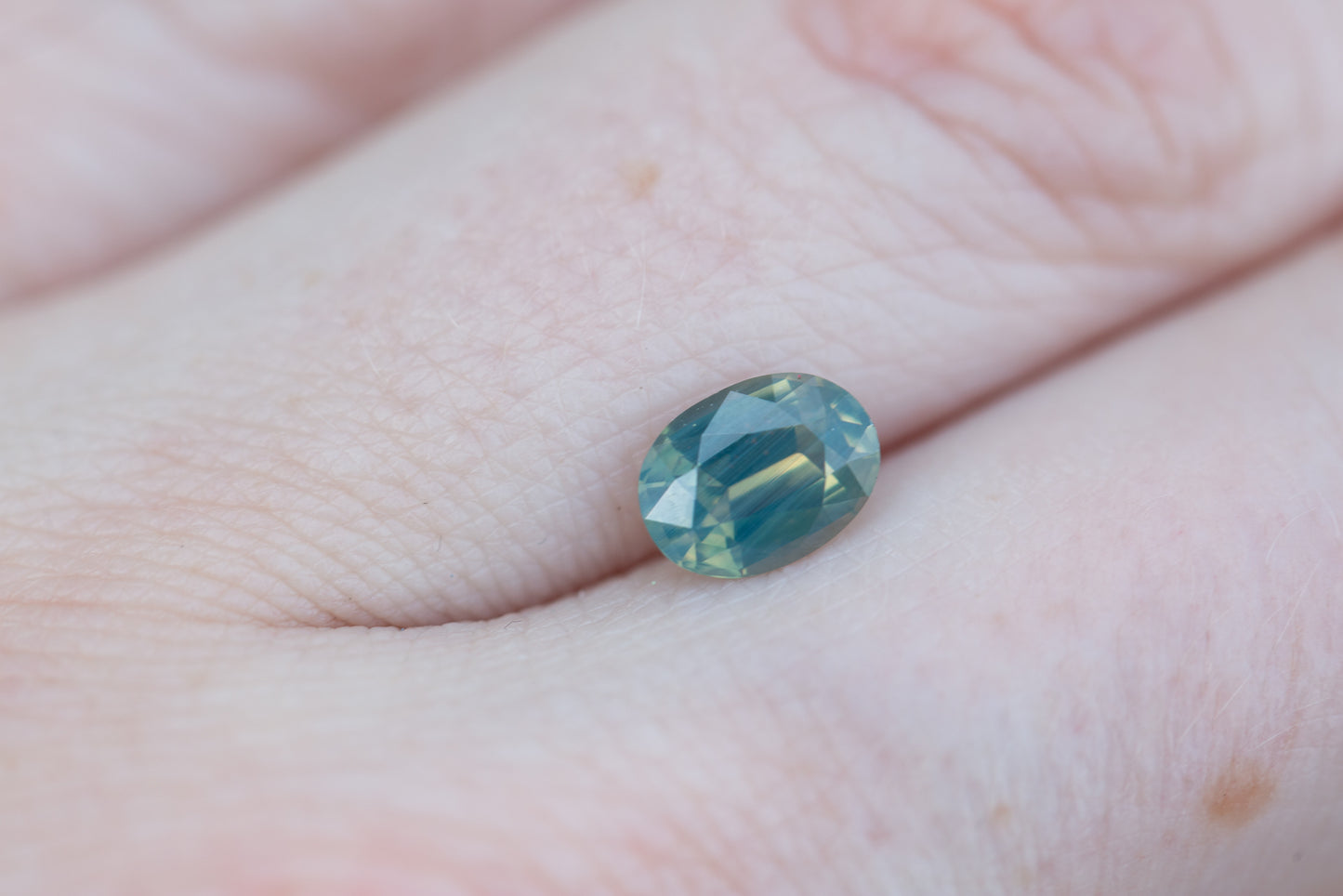 Load image into Gallery viewer, 1.28ct oval opalescent green teal sapphire
