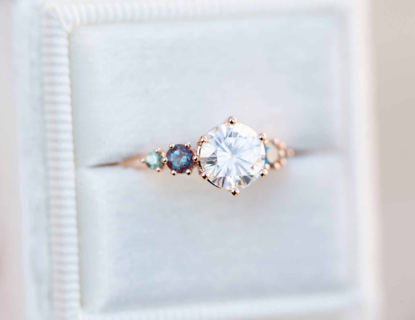Five stone ring with round moissanite and gemstone side stones