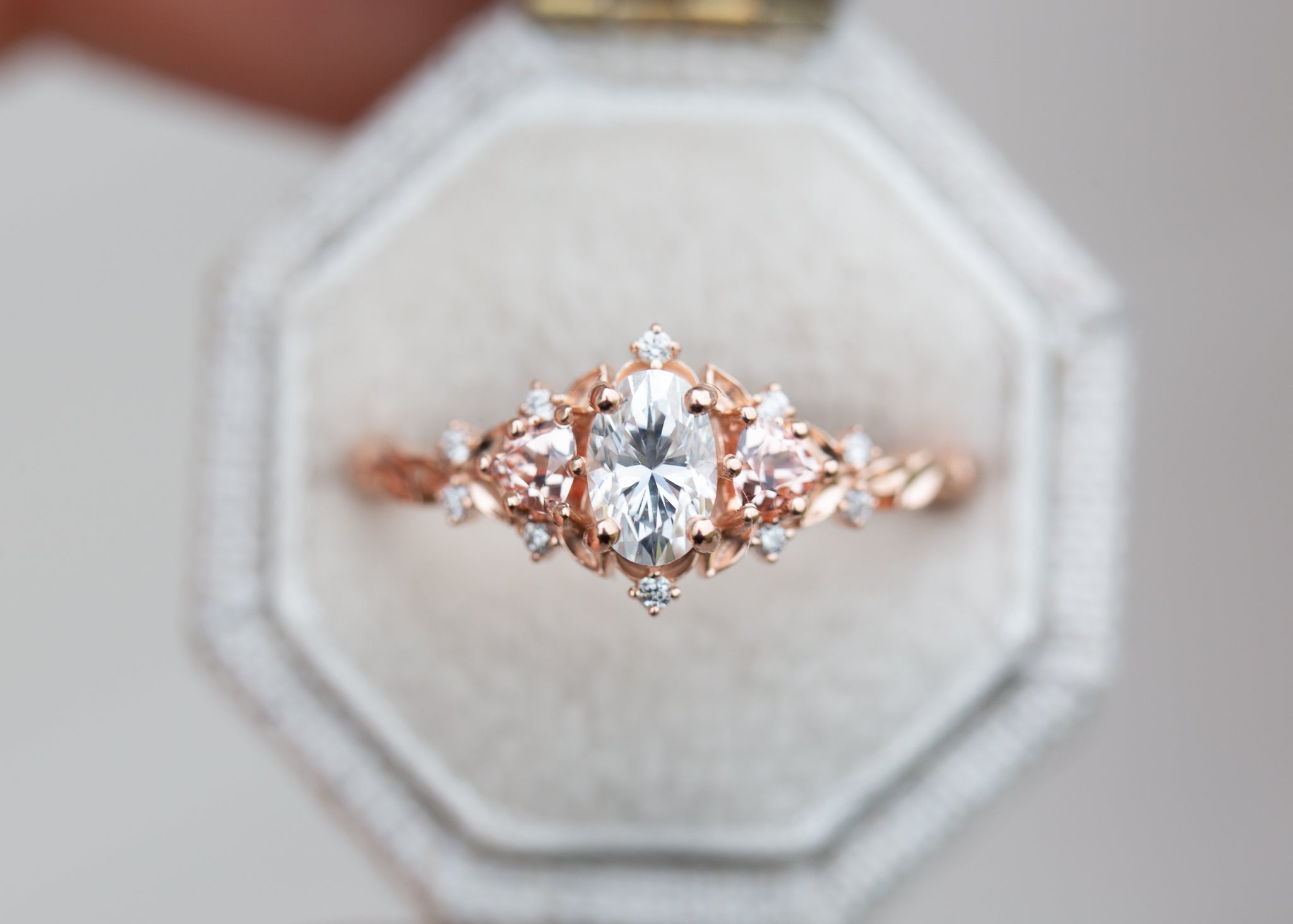 Briar Rose Three Stone with oval moissanite and lab peach sapphire