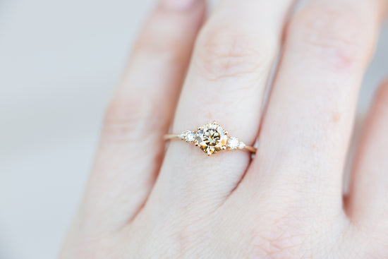 Round champagne moissanite five stone ring