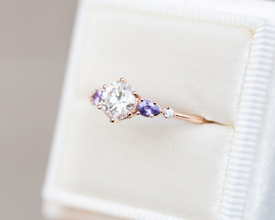 Round moissanite five stone ring with purple sapphires