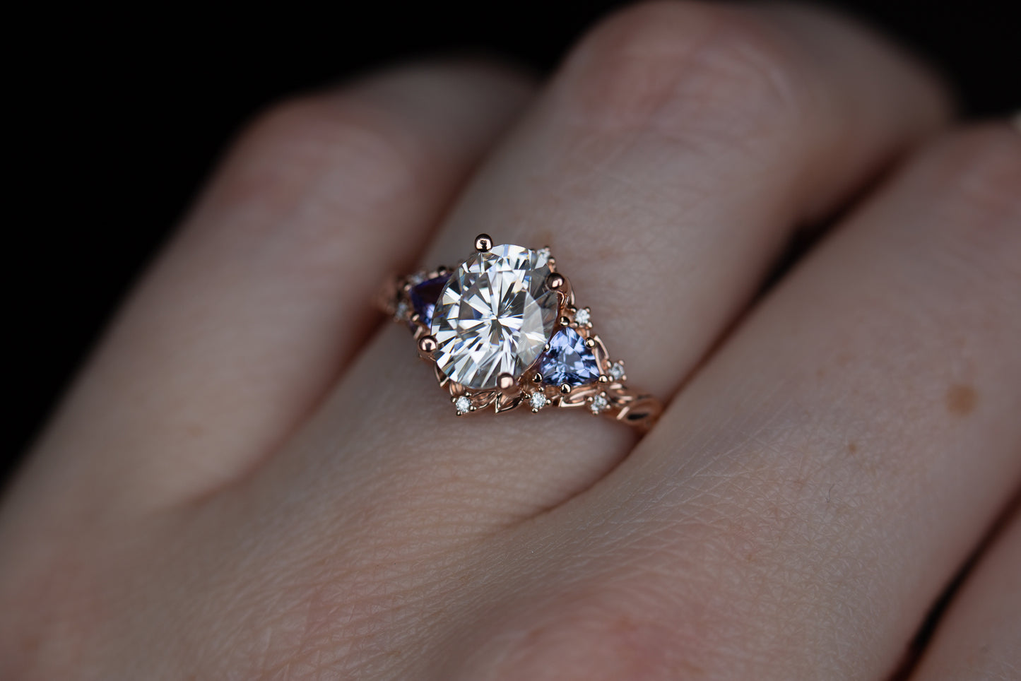 Load image into Gallery viewer, Briar rose three with 9x7mm oval moissanite and tanzanite side stones
