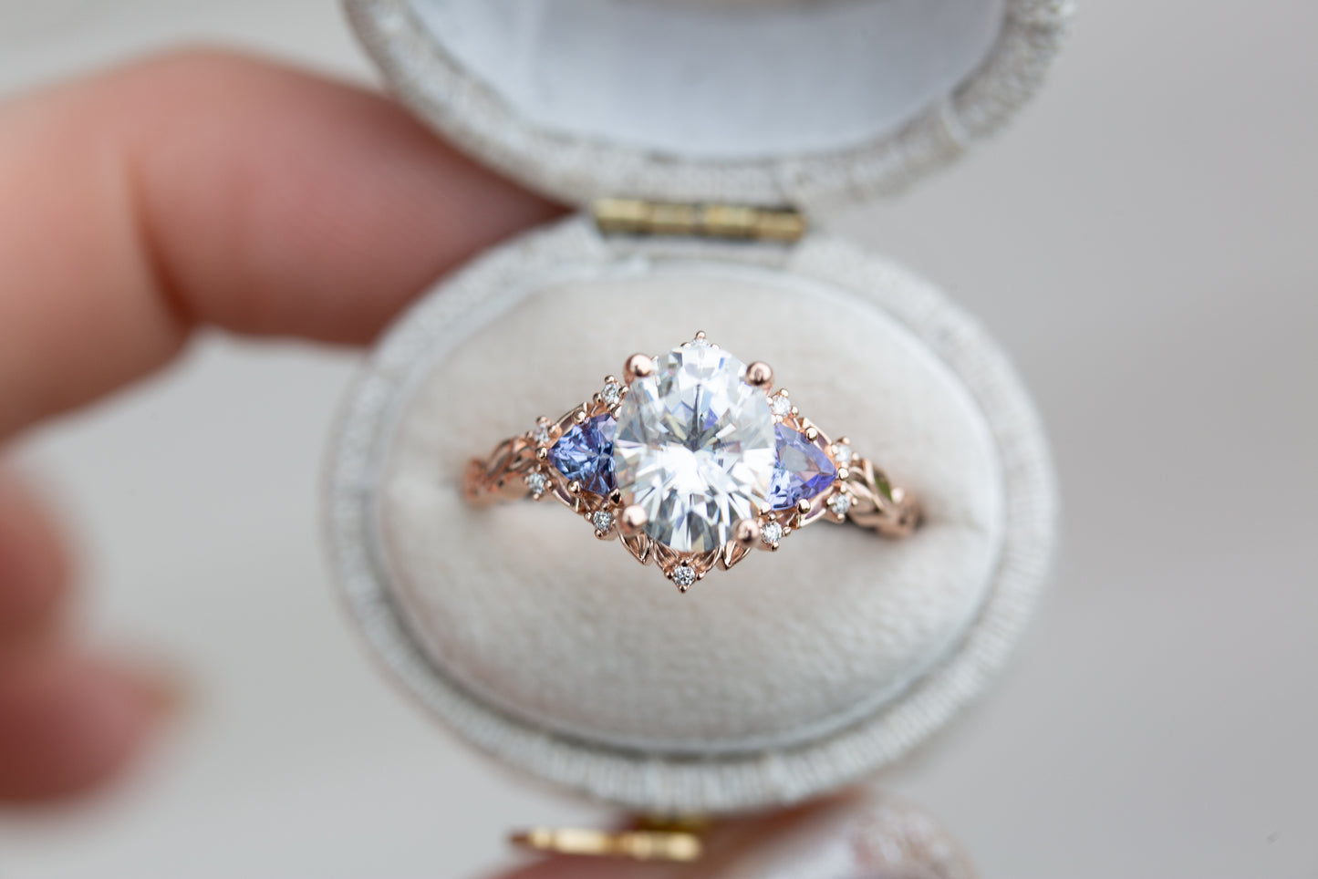 Load image into Gallery viewer, Briar rose three with 9x7mm oval moissanite and tanzanite side stones
