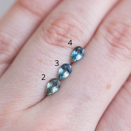 Pear teal Montana sapphire five stone ring with diamonds and lavender sapphire