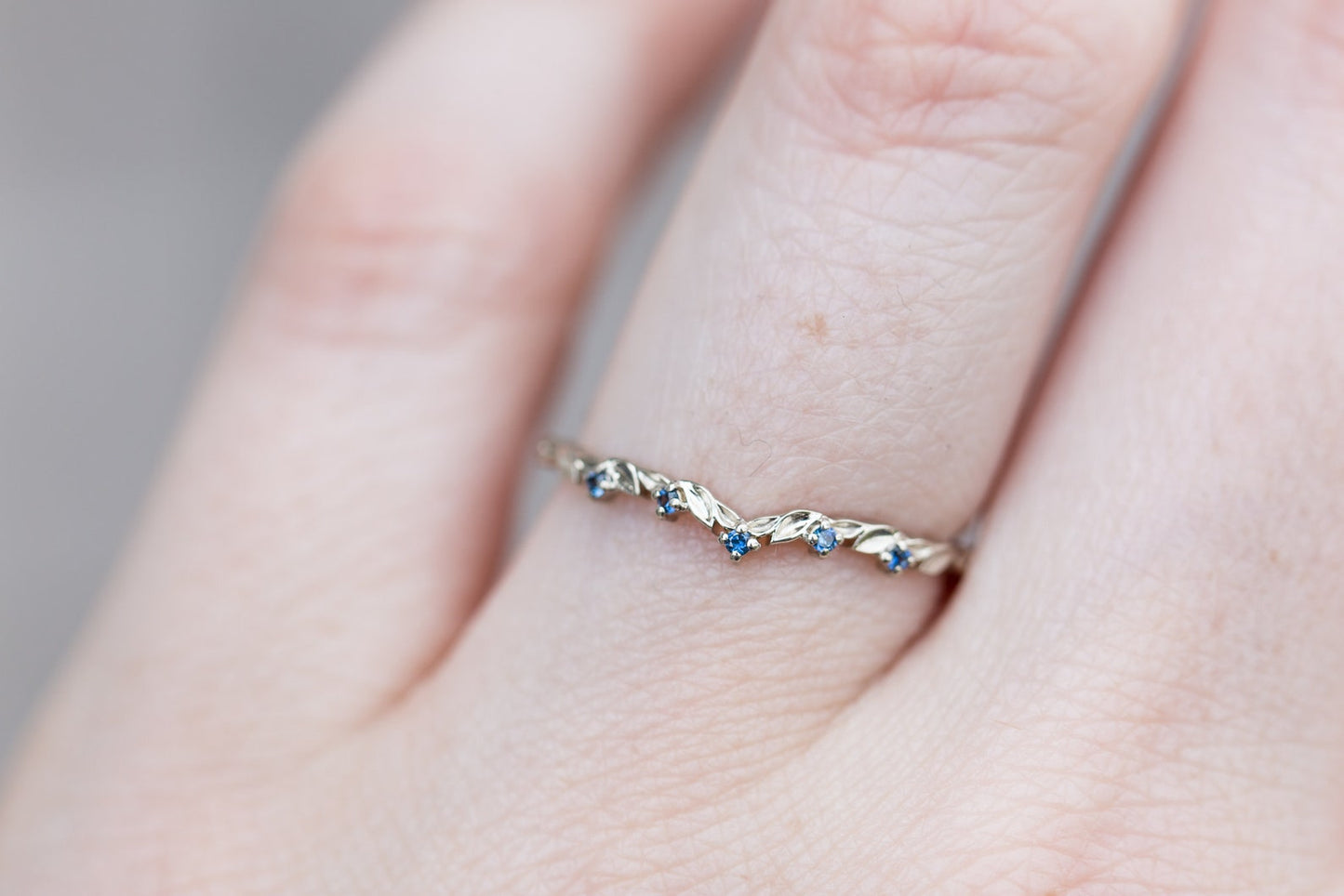 Blue sapphire curved leaf wedding band