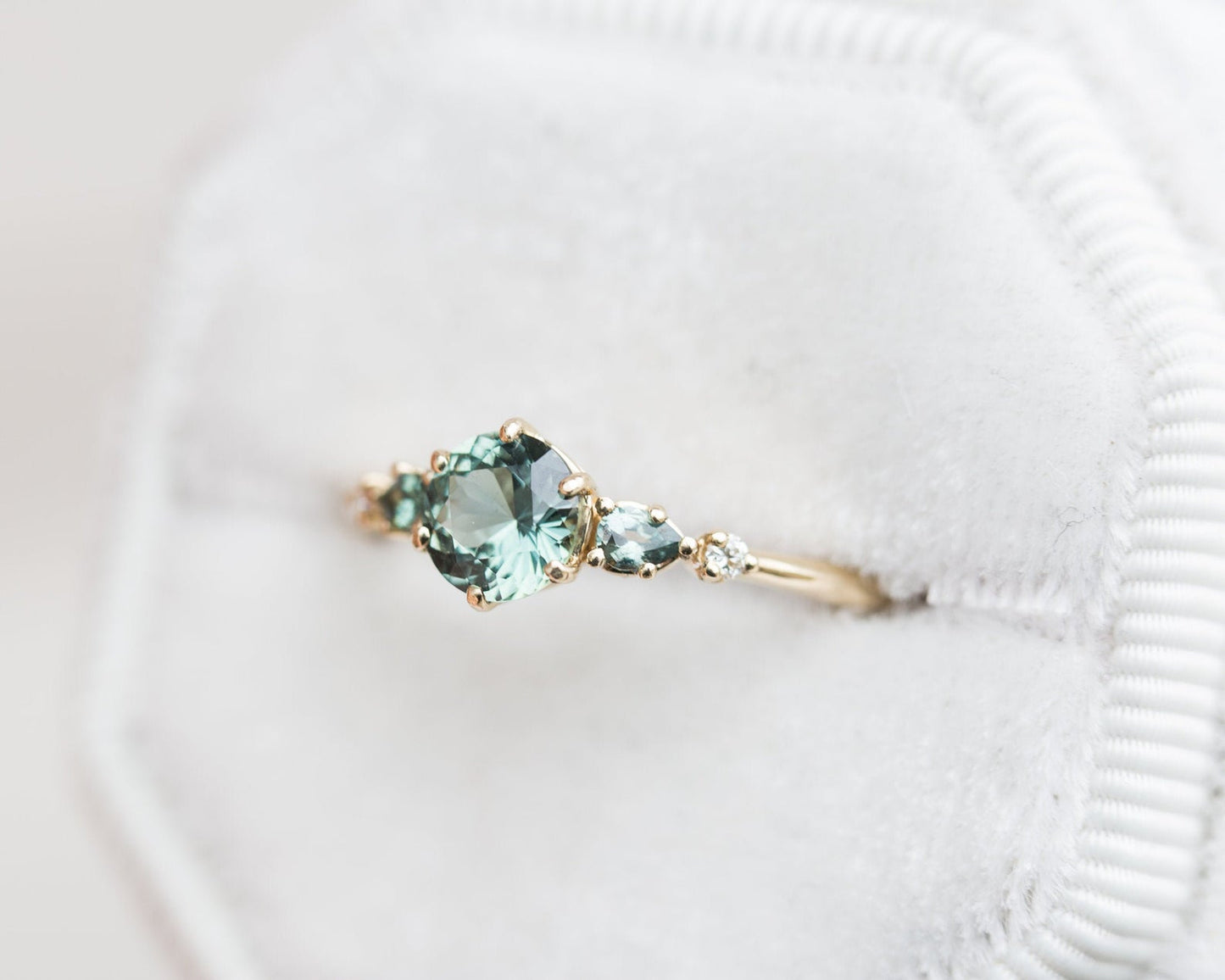 Round teal sapphire five stone ring