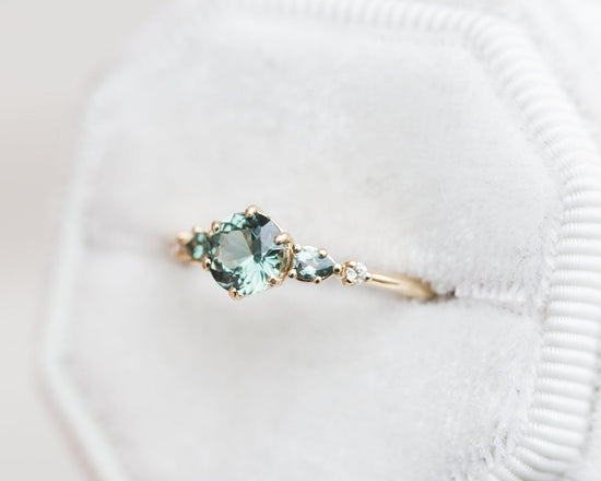 Round teal sapphire five stone ring
