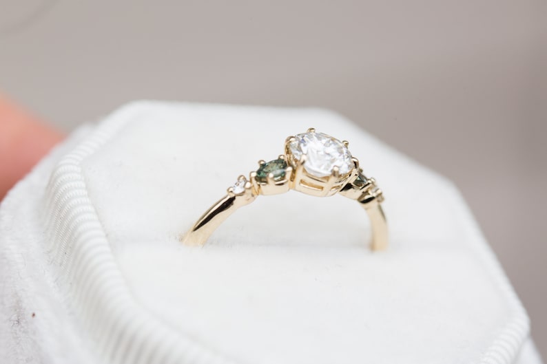 Load image into Gallery viewer, Round moissanite five stone with teal sapphire side stones
