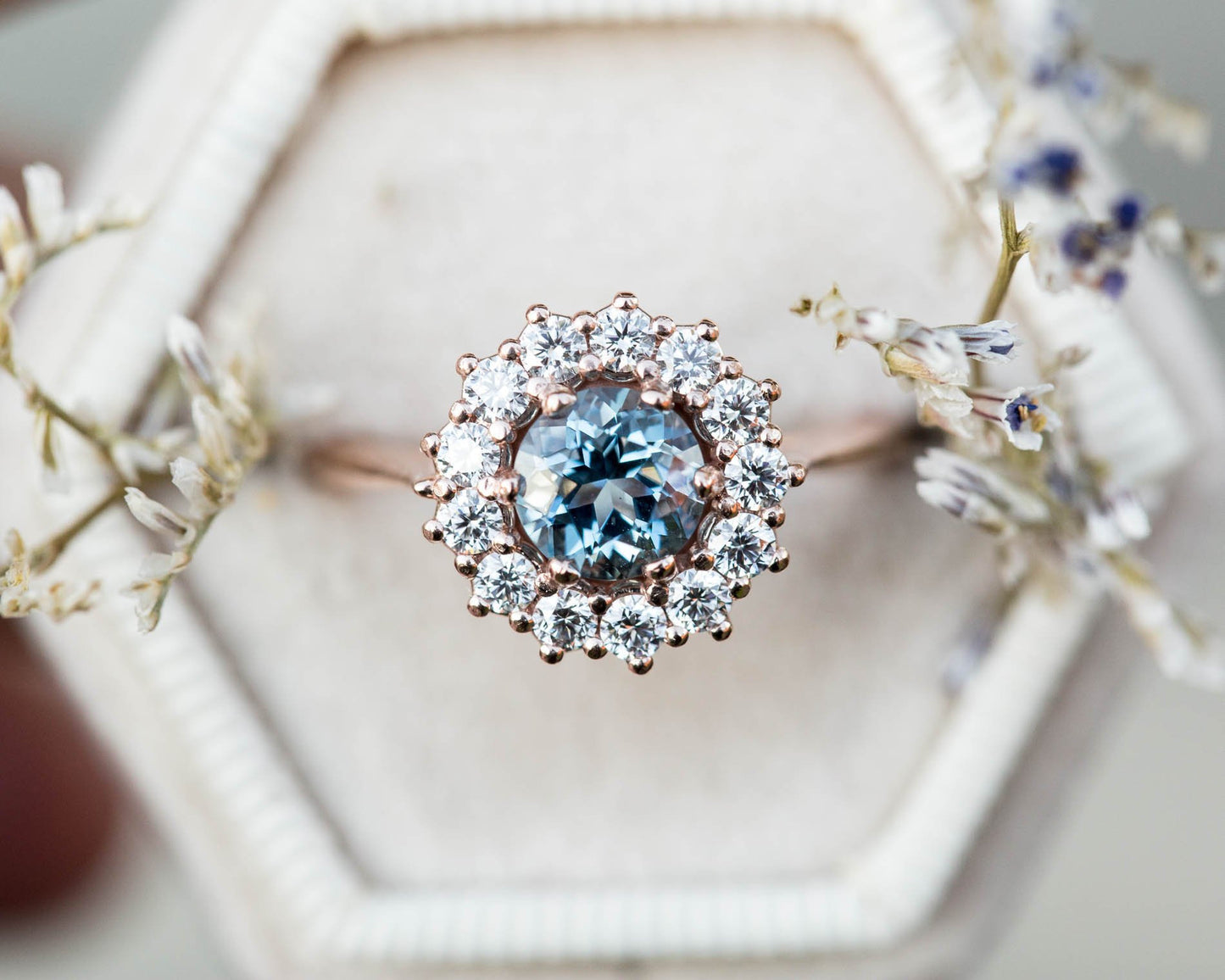 Cluster halo ring with aquamarine and diamonds